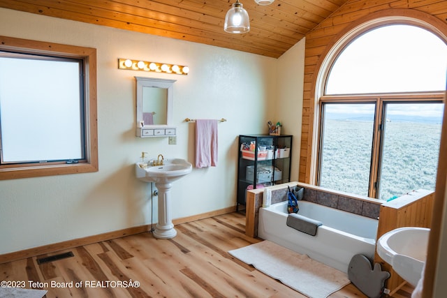 4 Beaver Ridge Rd, Daniel, WY 83115 - full bath featuring a bathtub, visible vents, wood finished floors, baseboards, and lofted ceiling