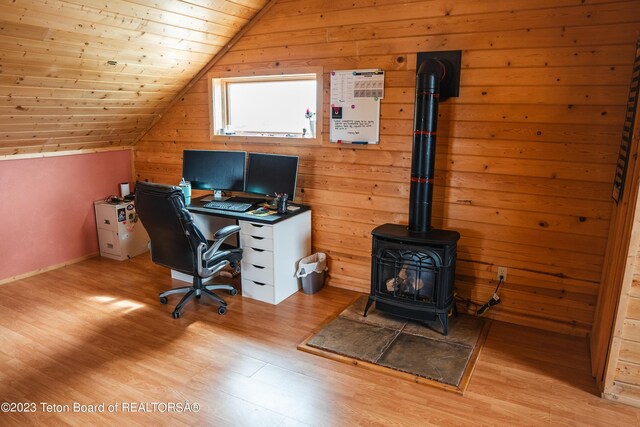 4 Beaver Ridge Rd, Daniel, WY 83115 - office area with vaulted ceiling, a wood stove, wood walls, and wood finished floors
