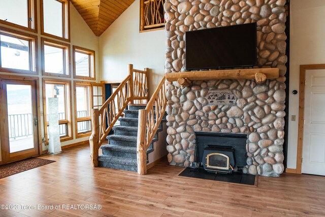 4 Beaver Ridge Rd, Daniel, WY 83115 - unfurnished living room featuring wood ceiling, a wood stove, wood finished floors, high vaulted ceiling, and stairs
