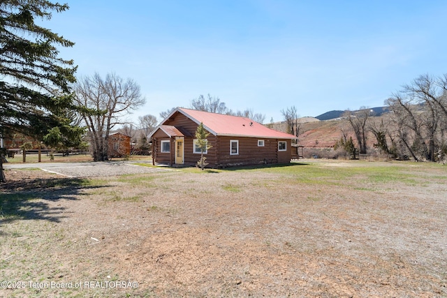611 W Ramshorn St, Dubois, WY 82513 - view of property exterior with metal roof and a mountain view