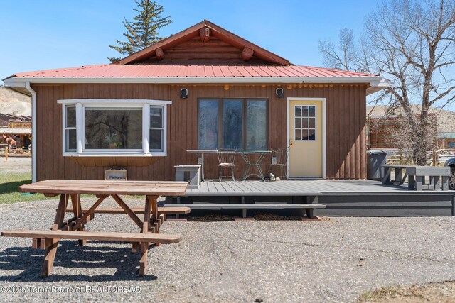 611 W Ramshorn St, Dubois, WY 82513 - rear view of property featuring a deck, an outdoor structure, and metal roof