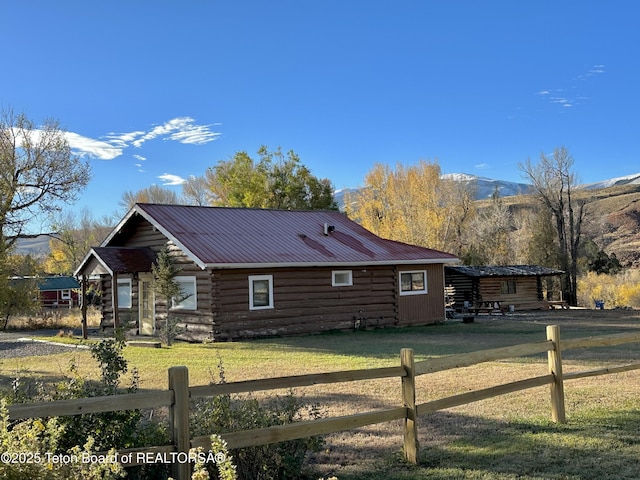 611 W Ramshorn St, Dubois, WY 82513 - view of side of property featuring log siding, metal roof, and a mountain view