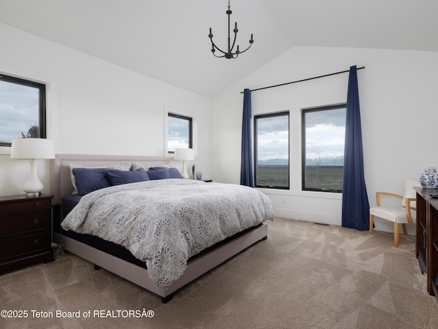 bedroom with high vaulted ceiling, multiple windows, a notable chandelier, and light carpet