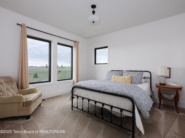 carpeted bedroom featuring baseboards