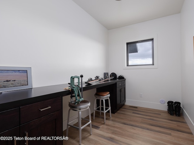 home office with baseboards and light wood-style flooring