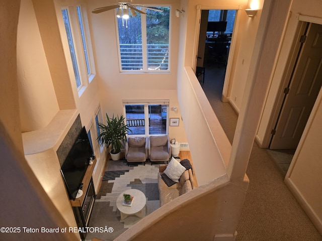 carpeted living room featuring a ceiling fan