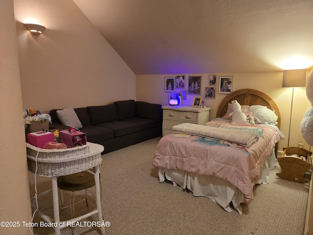 carpeted bedroom featuring lofted ceiling