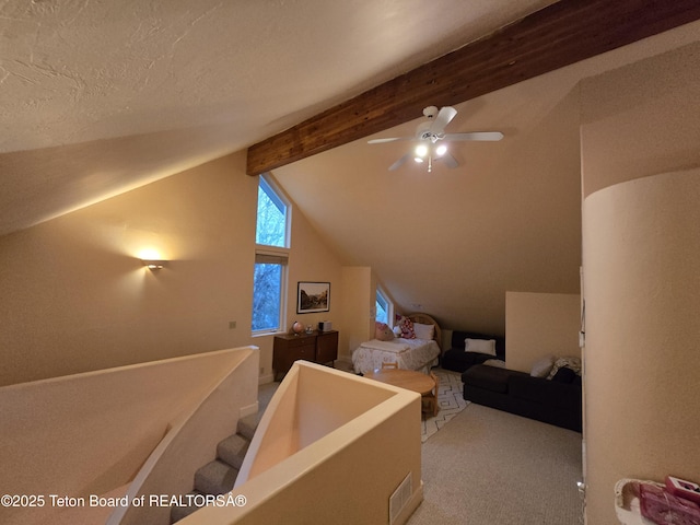 additional living space featuring carpet flooring, lofted ceiling with beams, and a ceiling fan