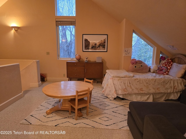 carpeted bedroom with vaulted ceiling and baseboards
