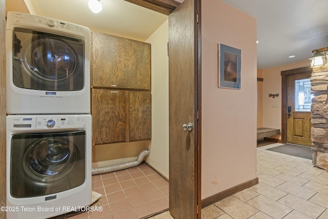 7250 N Rachel Way Unit 6, Teton Village, WY 83025 - washroom with stacked washer / drying machine, light tile patterned floors, and baseboards