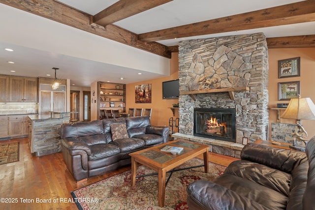 7250 N Rachel Way Unit 6, Teton Village, WY 83025 - living room with wood-type flooring, a stone fireplace, beam ceiling, and recessed lighting