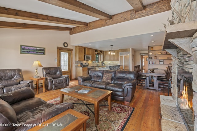 7250 N Rachel Way Unit 6, Teton Village, WY 83025 - living room featuring hardwood / wood-style floors, a stone fireplace, a baseboard radiator, and recessed lighting