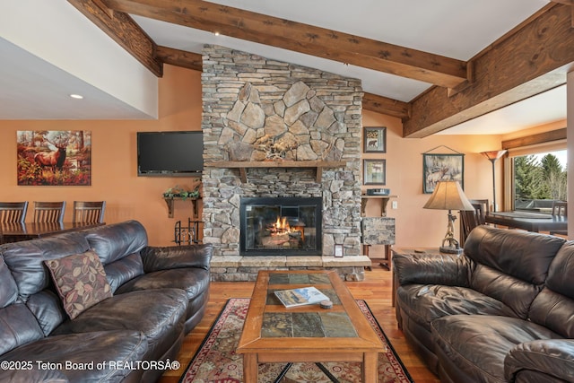 7250 N Rachel Way Unit 6, Teton Village, WY 83025 - living room with wood finished floors, beamed ceiling, and a stone fireplace