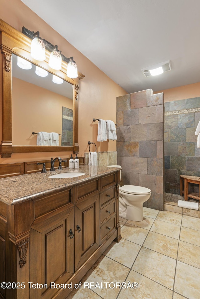 7250 N Rachel Way Unit 6, Teton Village, WY 83025 - full bath featuring tile walls, a walk in shower, vanity, toilet, and tile patterned flooring