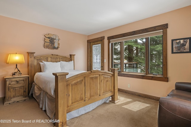7250 N Rachel Way Unit 6, Teton Village, WY 83025 - bedroom featuring light carpet, access to exterior, and baseboards
