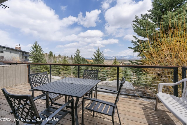 7250 N Rachel Way Unit 6, Teton Village, WY 83025 - wooden deck featuring outdoor dining area and a mountain view
