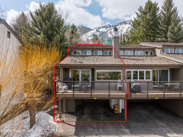 7250 N Rachel Way Unit 6, Teton Village, WY 83025 - rear view of house featuring a chimney and a deck with mountain view
