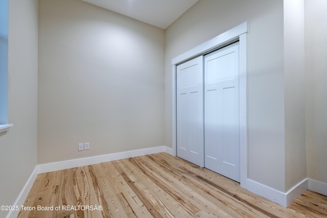 4444 Tails Down Rd, Tetonia, ID 83452 - unfurnished bedroom featuring wood finished floors, baseboards, and a closet