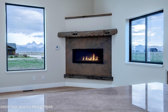4444 Tails Down Rd, Tetonia, ID 83452 - detailed view of a mountain view, wood finished floors, a lit fireplace, and baseboards