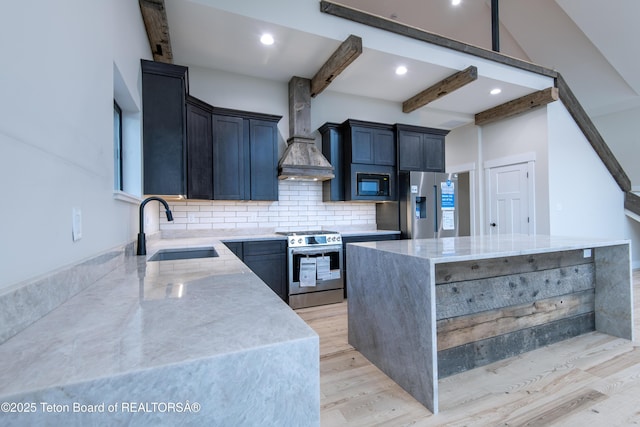 4444 Tails Down Rd, Tetonia, ID 83452 - kitchen featuring stainless steel appliances, a sink, wall chimney range hood, light stone countertops, and a center island