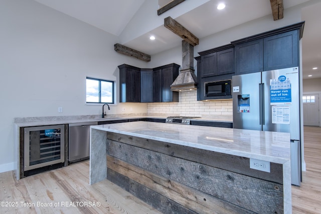 4444 Tails Down Rd, Tetonia, ID 83452 - kitchen featuring wine cooler, appliances with stainless steel finishes, a sink, light stone counters, and custom range hood