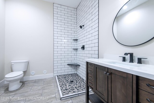 4444 Tails Down Rd, Tetonia, ID 83452 - bathroom featuring toilet, tiled shower, and vanity