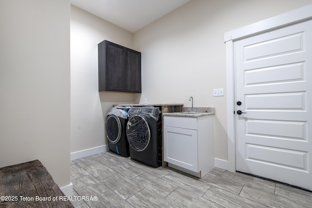 4444 Tails Down Rd, Tetonia, ID 83452 - washroom featuring cabinet space, washer and clothes dryer, baseboards, and wood finish floors