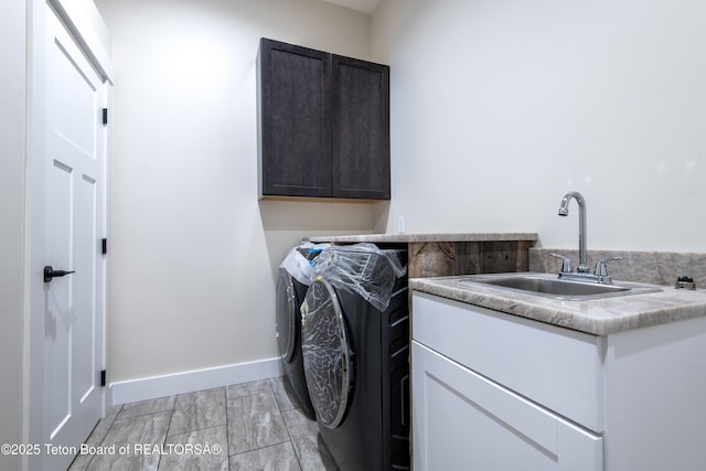 4444 Tails Down Rd, Tetonia, ID 83452 - clothes washing area featuring cabinet space, washer and clothes dryer, and baseboards