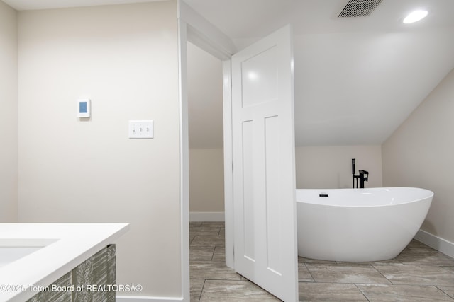 4444 Tails Down Rd, Tetonia, ID 83452 - full bath with a soaking tub, baseboards, wood tiled floors, vanity, and recessed lighting