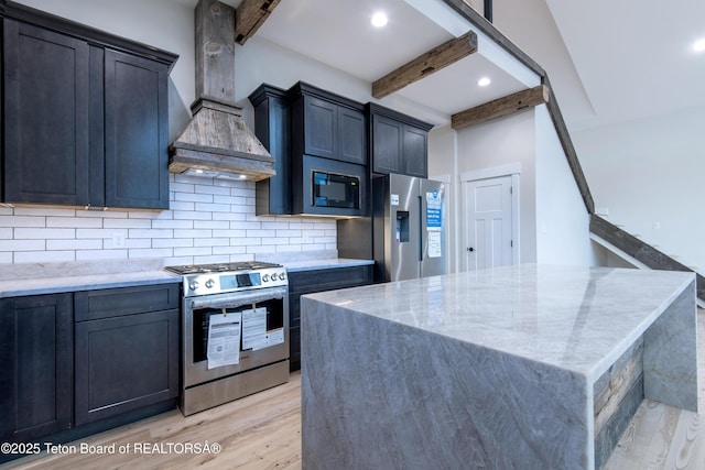 4444 Tails Down Rd, Tetonia, ID 83452 - kitchen with stainless steel appliances, beam ceiling, light wood-type flooring, light stone counters, and backsplash