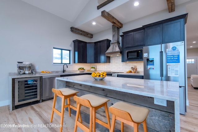 4444 Tails Down Rd, Tetonia, ID 83452 - kitchen featuring beverage cooler, stainless steel appliances, a sink, custom exhaust hood, and light wood-style flooring