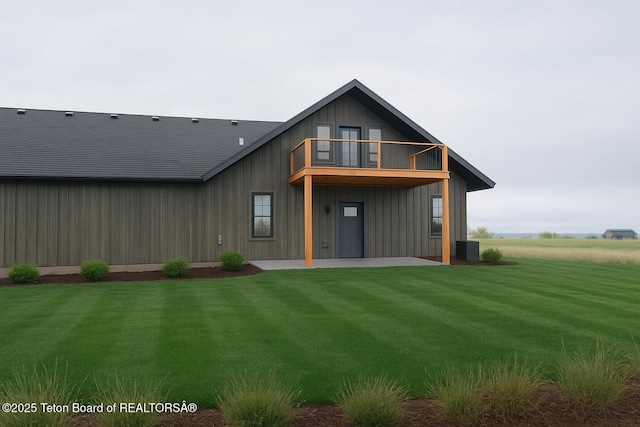 4444 Tails Down Rd, Tetonia, ID 83452 - rear view of house with a balcony, a patio area, a lawn, and board and batten siding