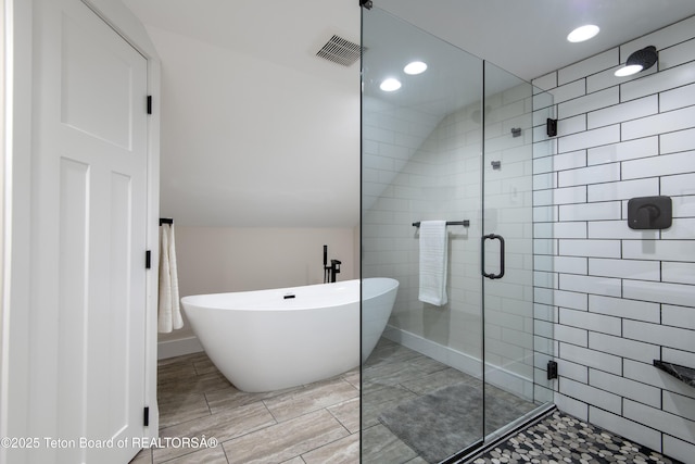 4444 Tails Down Rd, Tetonia, ID 83452 - full bath with a stall shower, a soaking tub, recessed lighting, and lofted ceiling