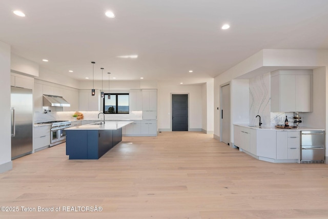 1404 Canyon Sunrise, Driggs, ID 83422 - kitchen with under cabinet range hood, high quality appliances, a sink, tasteful backsplash, and recessed lighting