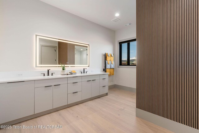 1404 Canyon Sunrise, Driggs, ID 83422 - bathroom featuring wood finished floors, double vanity, and recessed lighting