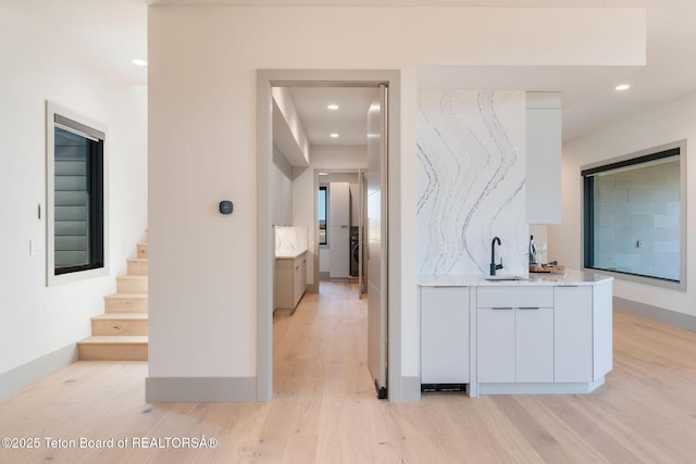 1404 Canyon Sunrise, Driggs, ID 83422 - hallway with light wood-style floors, a sink, recessed lighting, and stairs