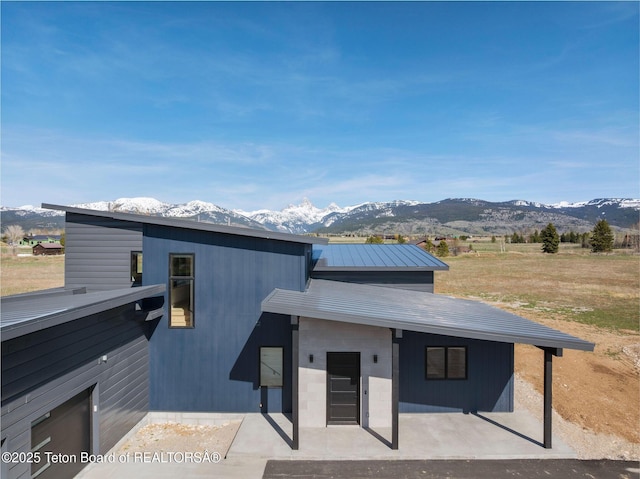 1404 Canyon Sunrise, Driggs, ID 83422 - view of front of property featuring a mountain view, a patio, and metal roof
