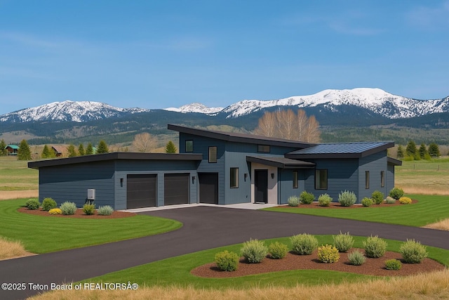 1404 Canyon Sunrise, Driggs, ID 83422 - modern home featuring a mountain view, an attached garage, and a front lawn