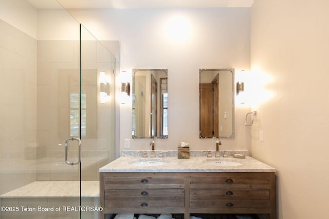 bathroom featuring a sink, double vanity, and a stall shower