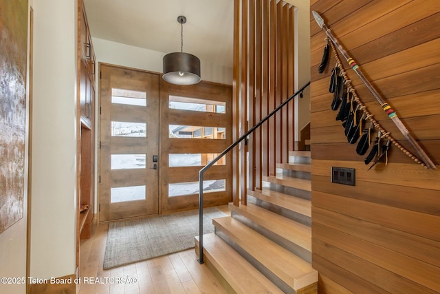 entryway with stairs and light wood-style floors