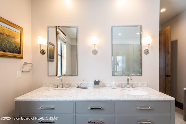 full bathroom with recessed lighting, double vanity, and a sink