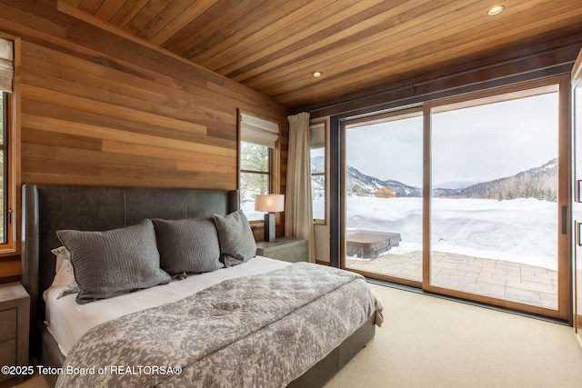 carpeted bedroom with recessed lighting, a mountain view, wood ceiling, wooden walls, and access to outside