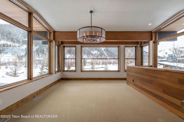 unfurnished sunroom with a chandelier and visible vents