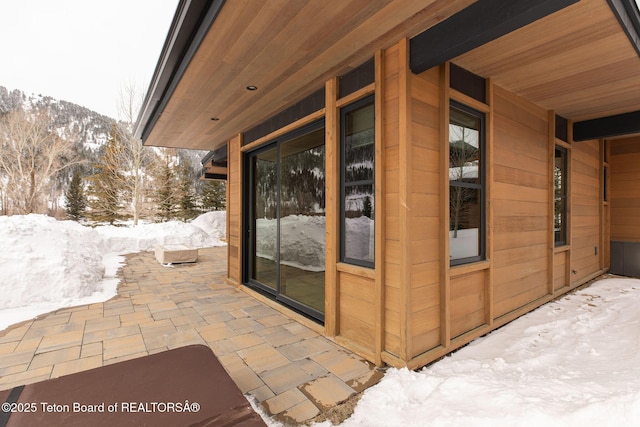 snow covered patio featuring a mountain view