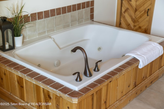 full bathroom featuring a jetted tub and tile patterned floors
