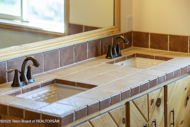 room details featuring tasteful backsplash and a sink
