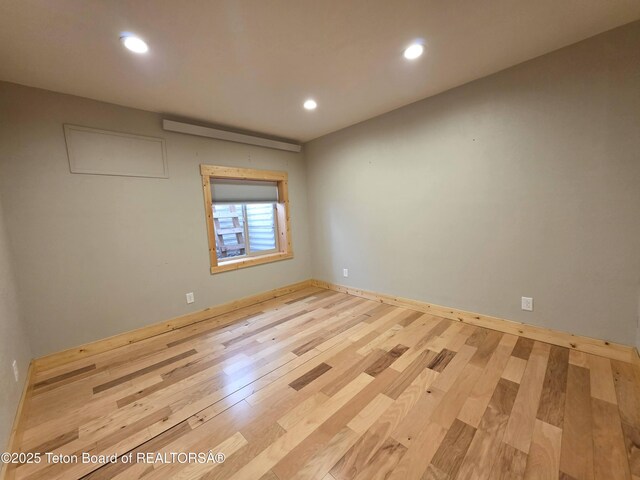 spare room with recessed lighting and wood finished floors