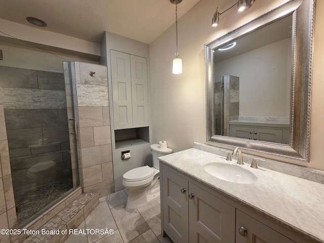 full bath with vanity, toilet, and a shower stall
