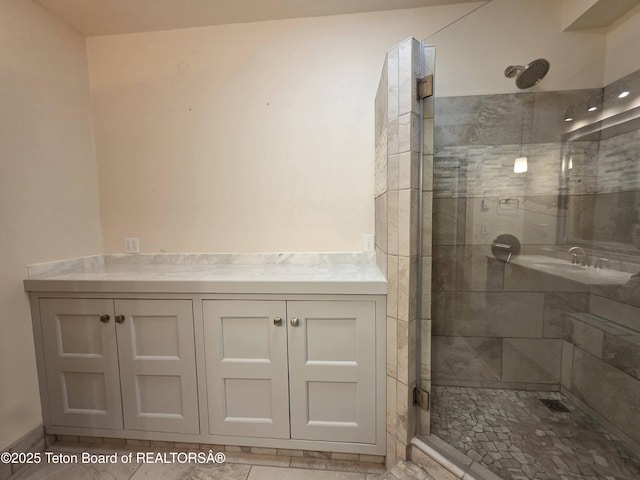 full bath featuring a tile shower and tile patterned floors