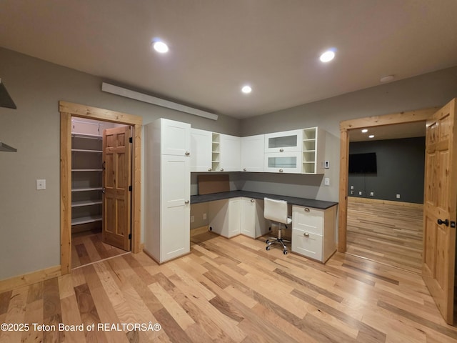office area with built in study area, light wood-style flooring, baseboards, and recessed lighting